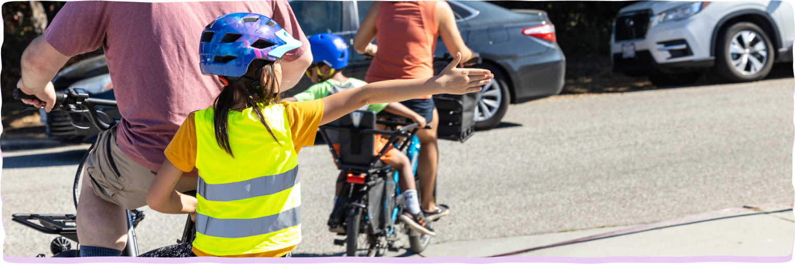 family biking and using hand signals